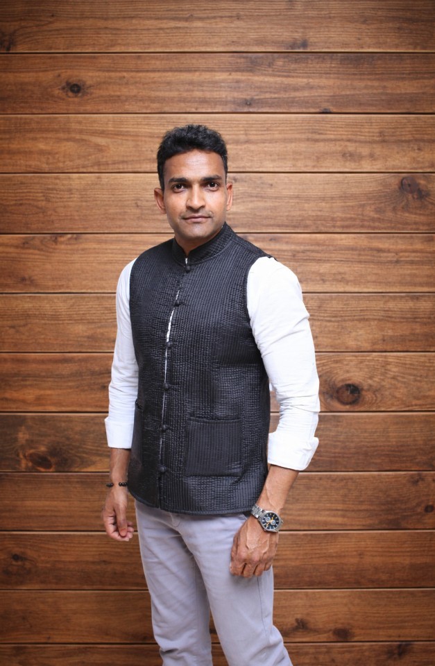 Man in Nehru jacket against wooden backdrop 3